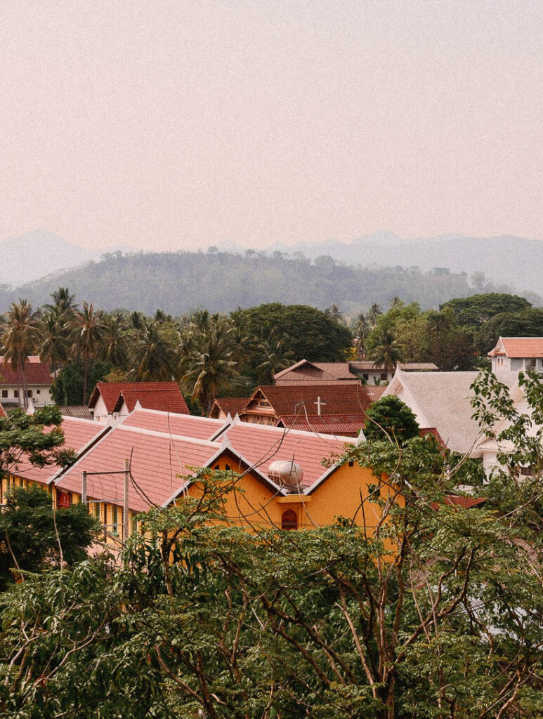 Elevated view of the rooftops in the lush green landscape of Belmond La Residence, Phou Vao, Laos.