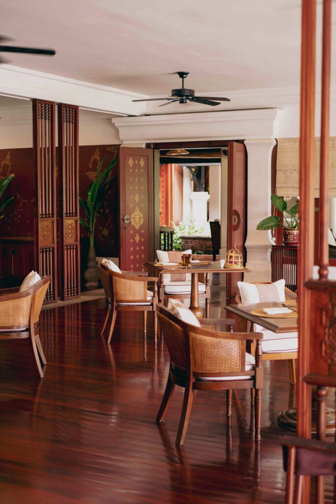 Elegant dining room at Belmond La Résidence Phou Vao with wooden furnishings and natural light