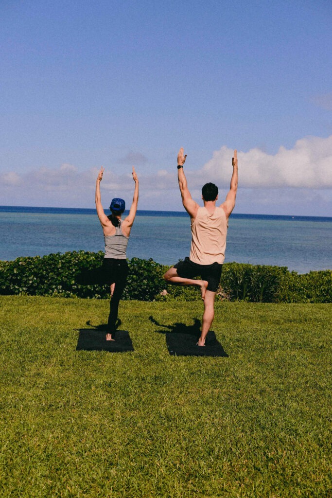 Guests practicing Tai Chi on the lawn at Hoshinoya Okinawa resort