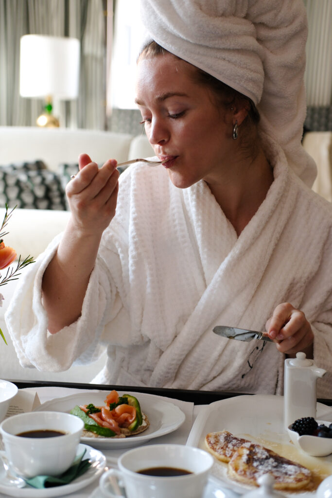 Editorial luxury hospitality photography of a signature breakfast in a hotel room
