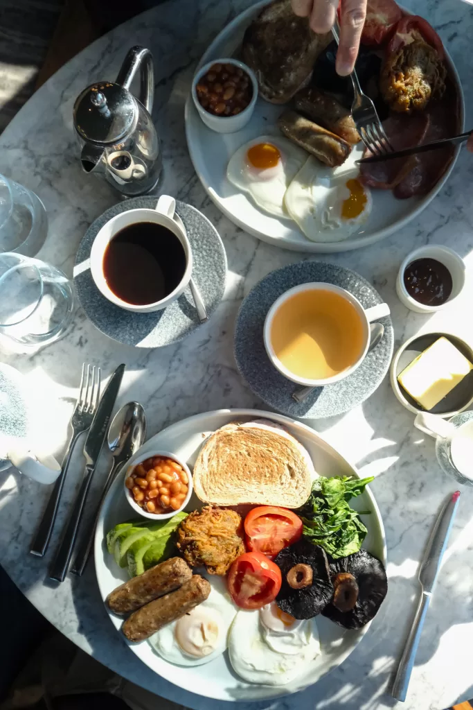 Full English breakfast and coffee served at The White Horses coastal hotel